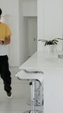 Vertical video: Asian man receiving envelope and reading letter on sofa as dad celebrating success. Family, celebration, achievement, home, connection, communication, vertical video - Powered by Shutterstock - Get 15% off with code: PIKWIZARD15