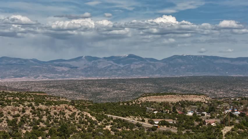 This cinematic drone timelapse features dramatic weather patterns as stormy clouds roll over the Santa Fe Baldy mountain peak. Ideal for atmospheric storytelling and high-altitude b-roll.
