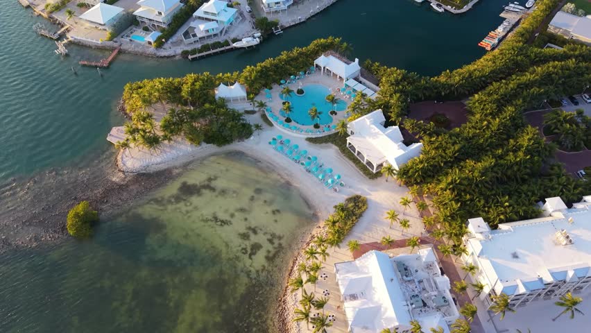 Expansive aerial drone view of the luxury Isla Bella Beach Resort in Marathon, Florida, showcasing coastal villas and the deep blue Atlantic.