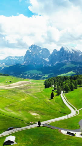 Pasture parcels in front of Alpe di Siusi peaks, in Dolomites, Italy. Aerial view