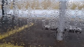 Condensation on train window pane overlooking blurred railway station platform. Atmosphere of travel and departure. Water droplets texture with foggy background of perron. Artistic urban view - Powered by Shutterstock - Get 15% off with code: PIKWIZARD15