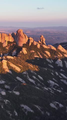 Sunlit peaks of Montserrat with rugged cliffs under a clear blue sky. A stunning natural landscape with mountains perfect for hiking, rock climbing, travel, and outdoor adventure imagery.
