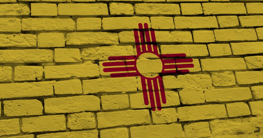 A panning video of a brick wall with the new mexico state flag of the United States of America