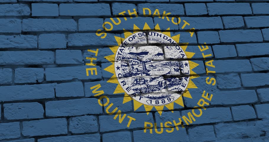 A panning video of a brick wall with the south dakota state flag of the United States of America