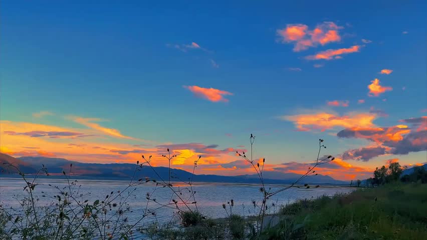 Serene sunset over a lake with mountains