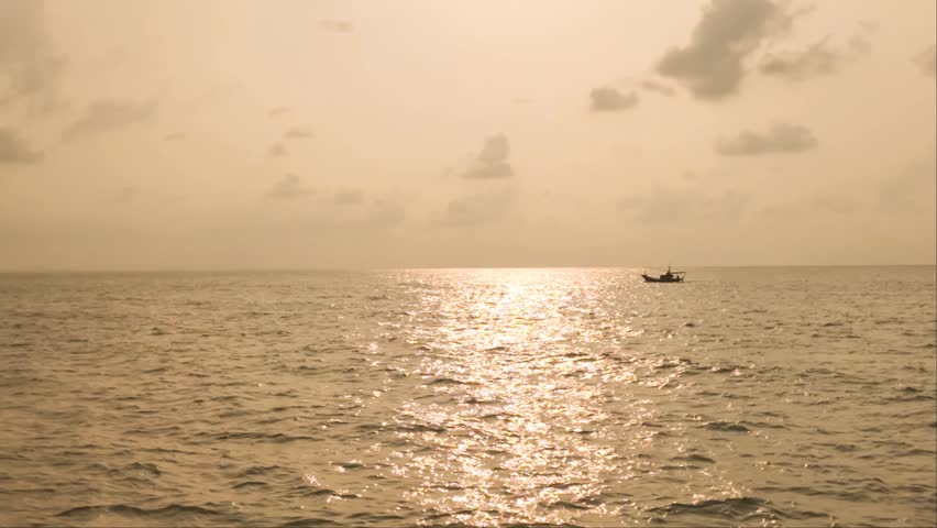 Serene Seascape Under Cloudy Skies: A tranquil ocean stretches endlessly towards the horizon, beneath a vast expanse of dramatic, cloud-filled skies, creating a sense of peace and contemplation.