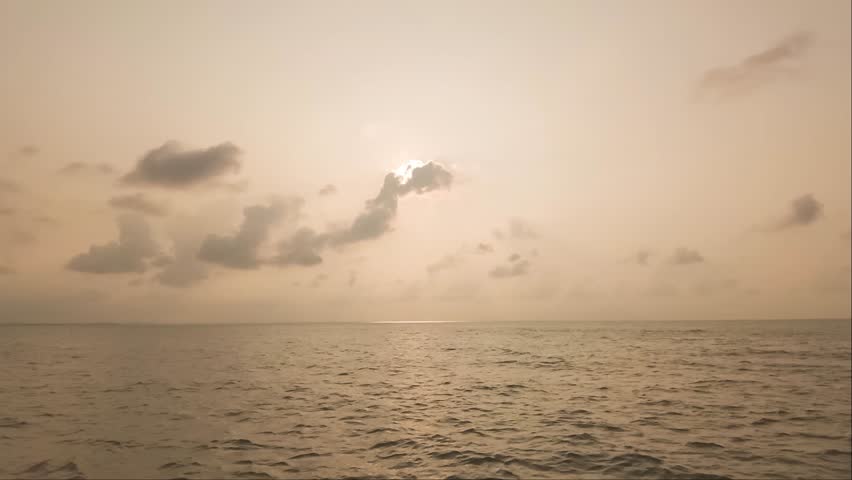 Serene Seascape Under Cloudy Skies: A tranquil ocean stretches endlessly towards the horizon, beneath a vast expanse of dramatic, cloud-filled skies, creating a sense of peace and contemplation.