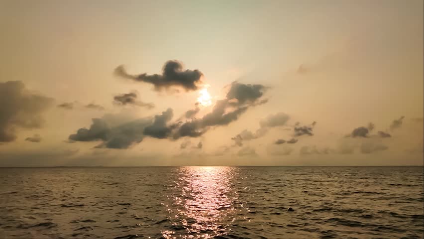 Serene Seascape Under Cloudy Skies: A tranquil ocean stretches endlessly towards the horizon, beneath a vast expanse of dramatic, cloud-filled skies, creating a sense of peace and contemplation.