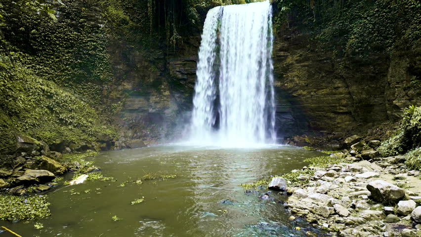 Scenic shots of powerful waterfalls plunging into natural pools and rocky streams, framed by dense tropical foliage in Lake Sebu, South Cotabato, Philippines.
