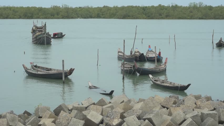 Scenic view of a cluster of traditional wooden boats floating on the tranquil Bakkhali River, Cox