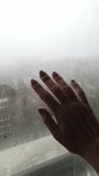 Female hand touches a steamy window, drawing abstract patterns on the condensation. Muted, natural light creates a melancholic and lonely mood on a foggy, rainy day. - Powered by Shutterstock - Get 15% off with code: PIKWIZARD15