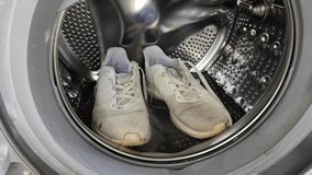 Washing dirty sneakers in a front load washing machine - Powered by Shutterstock - Get 15% off with code: PIKWIZARD15