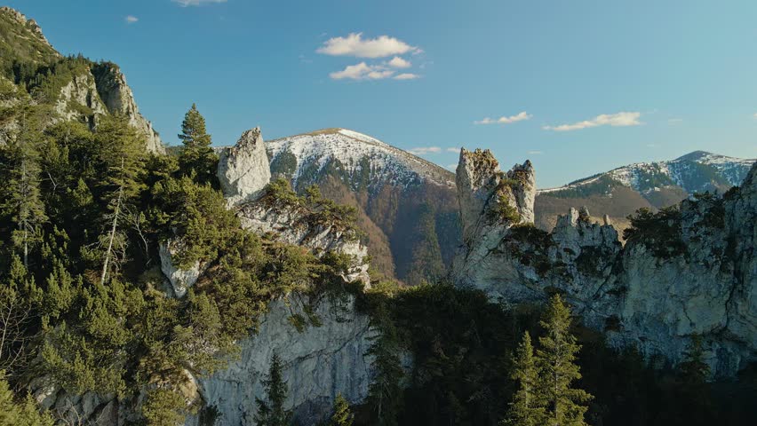 Aerial View Of Rugged Peaks. Peaceful Landscape With Snowtopped Summits And Lush Pine Woods