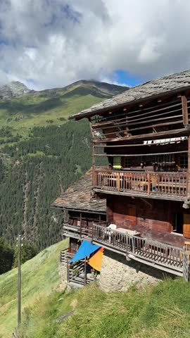 Traditional Swiss Alpine chalet with wooden balconies in the mountain village of La Sage, Valais, Switzerland