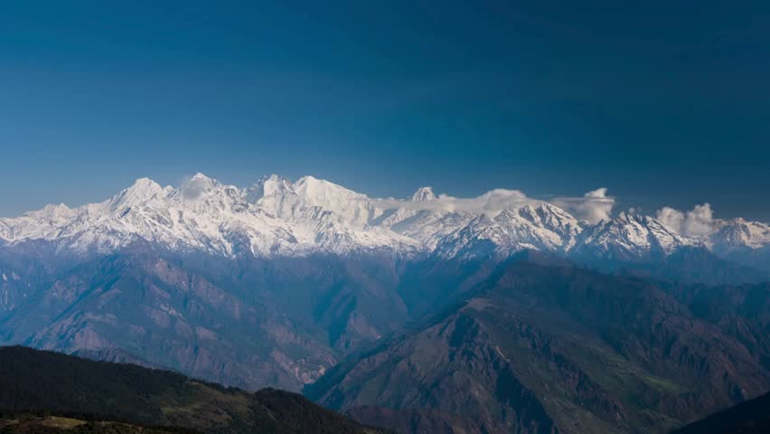 Spectacular view of snow-capped Himalayan peaks towering over lush valleys, showcasing the breathtaking beauty of Nepal