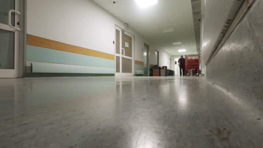 A wide lowangle perspective of a clean, brightly lit hospital hallway in Warsaw, Poland. Suitable for healthcare, emergency, and medical infrastructure themes.