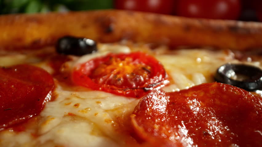 Appetizing Piece of Pizza Prepared for Eating , Camera Passing Just Above the Pizza , Unique Angle of View , Super Slow Motion