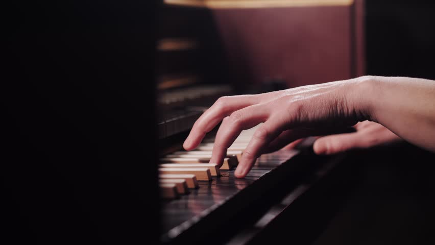 Close-Up Pianist Hands Playing Harpsichord Piano Keys in Warm Light