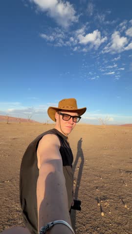Exploring the Namib Desert: A Late Afternoon Walk Amidst Sand Dunes and Sparse Vegetation