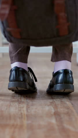 Anxiety, feet and student in high school for education, quiz stress and adhd for learning difficulty. Shoes, child and teenager with nervous tapping for exam worry, studying and space in classroom