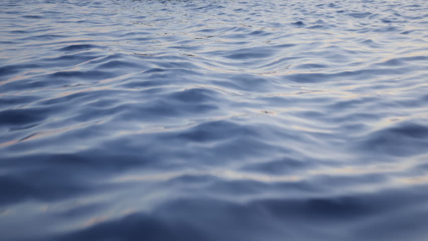 Camera orbits around an anchored crude oil super tanker to reveal more anchored ships. Aerial view of oil tankers anchored offshore in the ocean. Strait of Hormuz blockade concept. 3d animation render