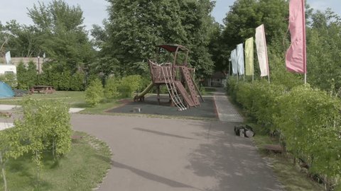 Aerial forward drone view of wooden playground in summer