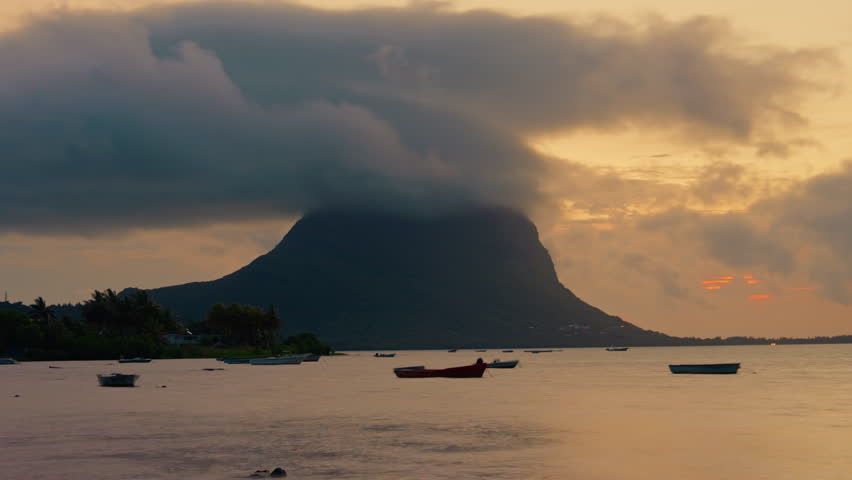 Timelapse of Le Morne Peninsula, Le Morne Brabant Mountain at sunset. Mauritius Island, Africa, Indian Ocean. Underwater waterfall in Le Morne