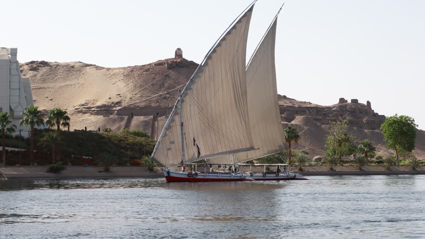 Traditional Egyptian Felucca boat sailing on the Nile near Aswan