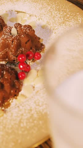Christmas cookies on plate with a glass of milk on wooden table during christmas time 4k