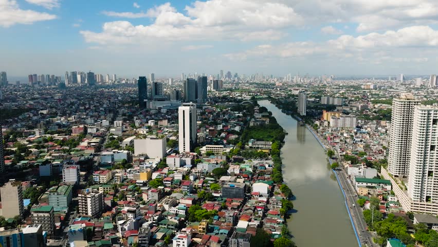 Cityscape: Drone view of modern buildings, hotels, and houses in riverside. Manila, Philippines.