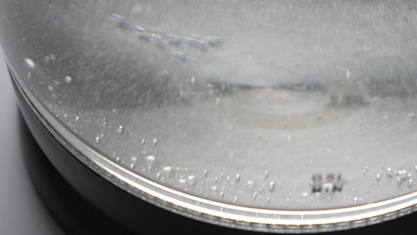 Boiling water in transparent glass kettle. Nobody