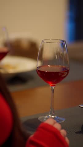 Woman holding a glass of red wine in a romantic atmosphere. Concept romantic atmosphere.