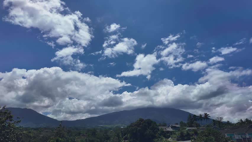 Heavy Clouds Rolling Over Mountain Peak and Village Time Lapse