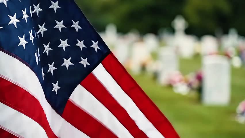 Usa memorial day, american flag waving in front of a cemetery with blurred headstones in the background, symbolizing remembrance, patriotism, and memorial day