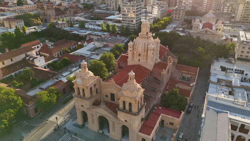 Beautiful aerial footage showing the cathedral of our lady of the assumption in cordoba, argentina, and the surrounding cityscape at sunset