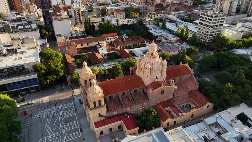 Aerial shot slowly rotating around the cathedral of córdoba, our lady of the assumption, revealing the cityscape and plaza san martin