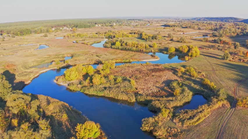 Autumn landscape of lush colorful trees growing along river