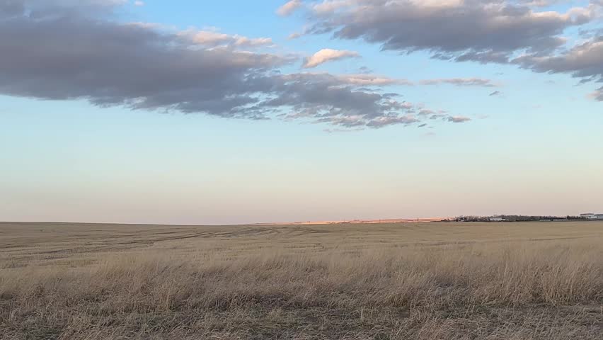 View of open prairie fields across rural Alberta countryside landscape