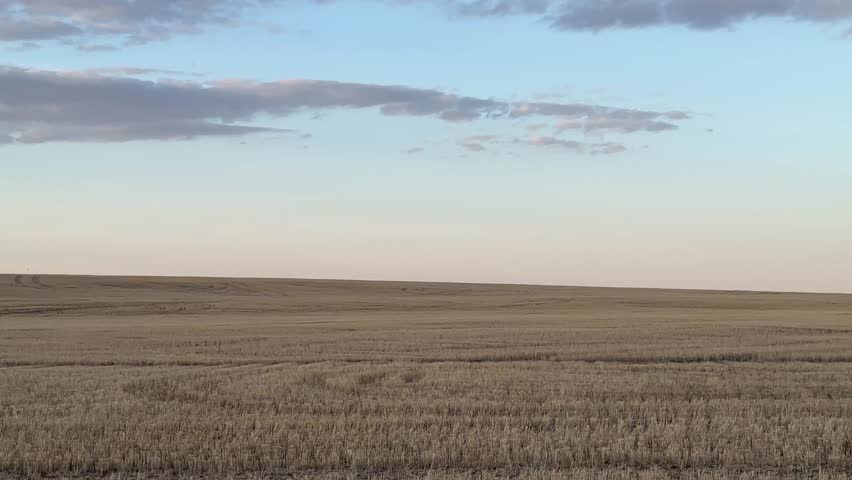 View of open prairie fields across rural Alberta countryside landscape