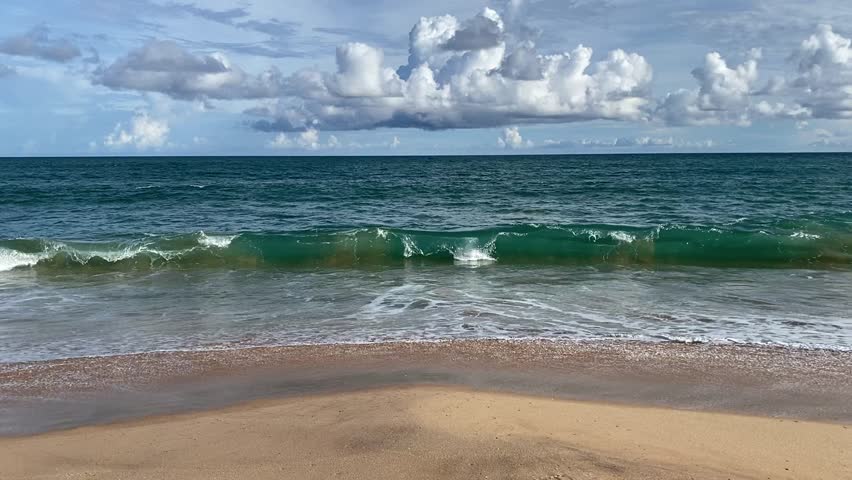Scenic slow motion video of sea waves crashing on a sandy tropical beach in Sri Lanka.
