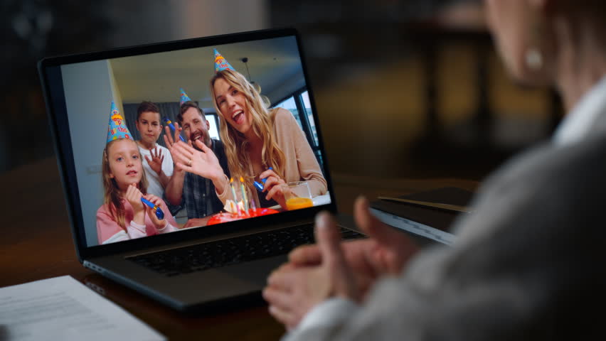 Woman talking video meeting by laptop with family at home closeup. Unrecognizable lady celebrating birthday at computer call remotely. Cheerful people enjoy distance internet communication in house