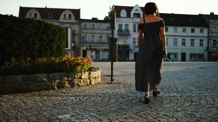 Young Attractive Woman, A Female Tourist, Walks Through The Historical Part Of A European City And Down An Old Street