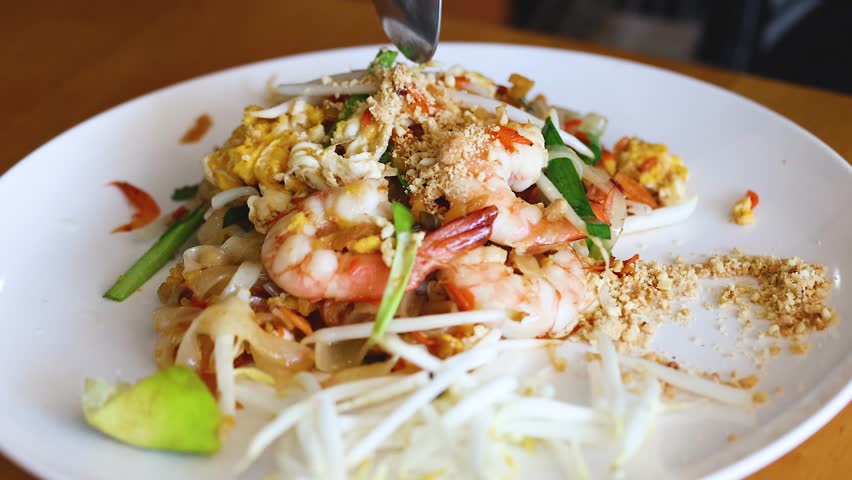 Pad thai noodles with shrimp, egg, bean sprouts, and peanuts.