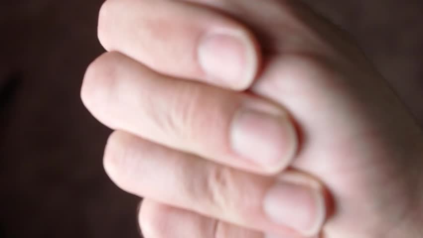 Hand with colorful wooden letters spelling 
