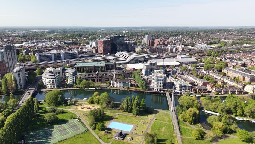 Establishing aerial view of The River Thames, Railway and train station in central Reading, Berkshire, United Kingdom