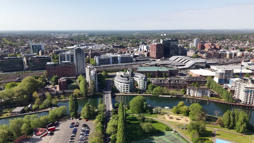 Establishing aerial view of The River Thames, Railway and train station in central Reading, Berkshire, United Kingdom