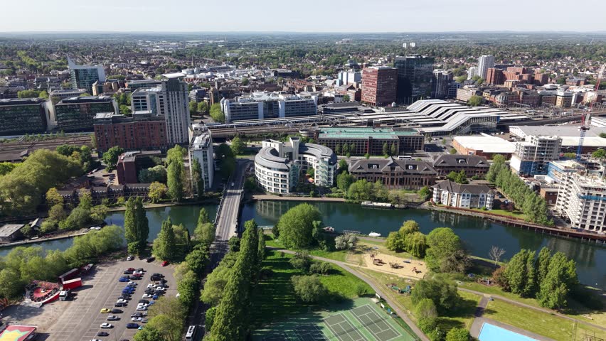 Establishing aerial view of The River Thames, Railway and train station in central Reading, Berkshire, United Kingdom