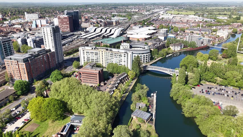 Establishing aerial view of The River Thames, Railway and train station in central Reading, Berkshire, United Kingdom