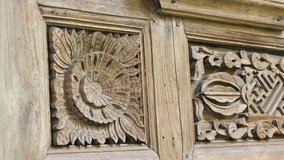 Wooden panel displays intricate carvings in detailed relief. Sunburst and geometric patterns adorn aged, textured surface. Handcrafted design evokes traditional craftsmanship and cultural heritage - Powered by Shutterstock - Get 15% off with code: PIKWIZARD15