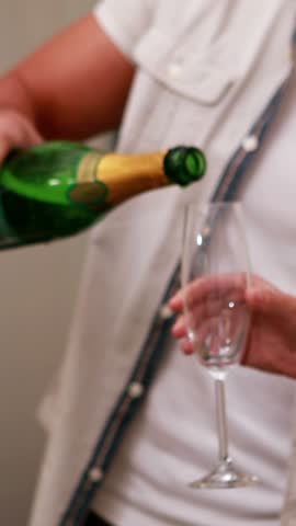 Casual business team celebrating with champagne in the office